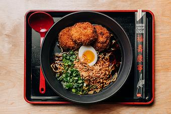 Product: this Filipino inspired ramen features our classic chicken broth, Sun Noodles,  adobo chicken meatballs and topped with scallions, fried garlic and fried shallots - Ramen San in Chicago, IL Restaurants/Food & Dining