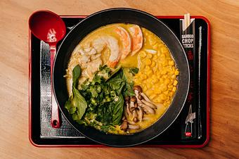Product: rich chicken broth, green curry miso, lemongrass, vietnamese sauce, coconut milk, shrimp, lump crab, buttered corn, beech mushrooms, lime, thai basil, cilantro, scallion - Ramen San in Chicago, IL Japanese Restaurants