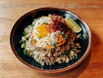 Product: thai chicken larb, garlic and ginger topped with a fried egg, chili threads and lime - RAMEN-SAN Whisky Bar in Fulton Market - Chicago, IL Japanese Restaurants