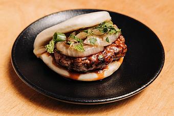 Product: limited edition: inspired by the delicious play of szechuan peppercorn and savory lamb this bun is balanced with sweet soy and charred onions on a steamed bun - RAMEN-SAN Whisky Bar in Fulton Market - Chicago, IL Japanese Restaurants