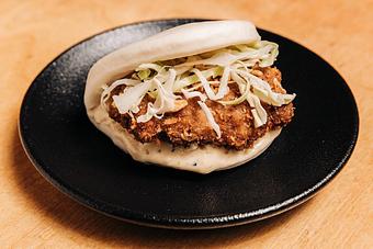 Product: limited edition: tsukune, a japanese chicken meatball, seasoned with five spice, garlic, and soy topped with shredded cabbage and kewpie mayo on a pillowy mantou bun - RAMEN-SAN Whisky Bar in Fulton Market - Chicago, IL Japanese Restaurants