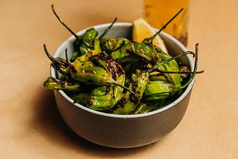 Product: blistered shishito peppers tossed in lemon and garlic, seasoned with salt and pepper - RAMEN-SAN Whisky Bar in Fulton Market - Chicago, IL Japanese Restaurants