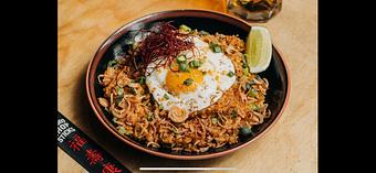 Product: featuring a blend of braised mushrooms, edamame, and spicy bean sprouts in a green kosho butter, with both a scrambled and fried egg - RAMEN-SAN Whisky Bar in Fulton Market - Chicago, IL Japanese Restaurants