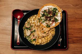 Product: our version of the traditional Mexican dish. our classic chicken broth with a salsa verde topped with poached chicken, white hominy, cabbage mix and a creamy tostada - RAMEN-SAN Whisky Bar in Fulton Market - Chicago, IL Japanese Restaurants