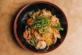 Product: this tossed noodle mazemen features temomi noodles in a creamy garlic sauce with parmesan cheese, poached shrimp, scallions and finished with dried shrimp powder, ichimi and rayu. - RAMEN-SAN Whisky Bar in Fulton Market - Chicago, IL Japanese Restaurants
