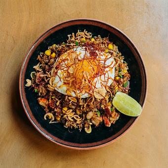 Product: this surf and turf duo fried rice features bites of bacon, lobster and corn tossed in a miso butter and topped with fried shallots and a fried egg. - RAMEN-SAN Whisky Bar in Fulton Market - Chicago, IL Japanese Restaurants