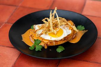 Product: SOURDOUGH BREAD, OAXACA AND JACK CHEESE, SERRANO HAM, FRIED EGG AND ANCHO CHILE BECHAMEL. - Red Mesa Restaurant in St Petersburg, FL Mexican Restaurants