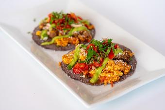 Product: Scrambled eggs, blue corn tortillas, queso fresco, cotija cheese, avocado sauce. - Red Mesa Restaurant in St Petersburg, FL Mexican Restaurants