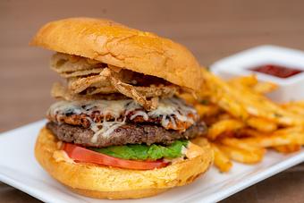 Product: Brioche bun, ground beef burger topped with chorizo, avocado, tomato, fried onions and chipotle mayo. Served with French fries and chipotle ketchup. - Red Mesa Restaurant in St Petersburg, FL Mexican Restaurants