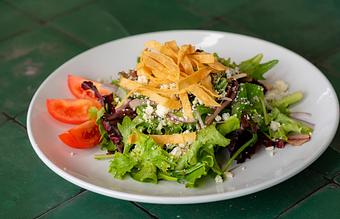 Product: Mixed greens, tomato, red onion, gorganzola cheese, corn strips, tomato-cilantro vinaigrette. - Red Mesa Restaurant in St Petersburg, FL Mexican Restaurants