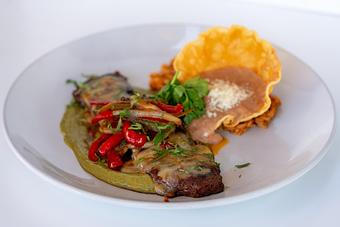 Product: Chimayo chile skirt steak, peppers, onions, Oaxaca cheese, avocado sauce, corn tortillas. Mexican rice & refried beans. - Red Mesa Restaurant in St Petersburg, FL Mexican Restaurants
