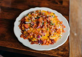Product: Hash browns topped with buffalo sauce, cheddar and pepper jack cheese and pico de gallo. - RJ Grunts in Lincoln Park - Chicago, IL American Restaurants