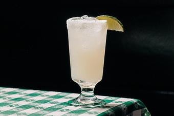 Product: a margarita cocktail in a tall glass garnished with a lime slice - RJ Grunts in Lincoln Park - Chicago, IL American Restaurants
