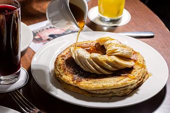 Product: Brown Butter Pancakes with banana and fosters sauce. - Roxy Bar in TriBeCa - New York, NY Bars & Grills
