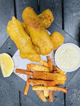 Product: fresh cod in a lightly & crunchy curry tempura, olives tartar sauce, smoked paprika parsley fries - Socarrat Paella Bar - Chelsea in Chelsea - New York, NY Spanish Restaurants