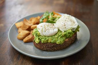 Product: AVOCADO TOAST | chunky avocado, two poached eggs, tomato toast, patatas bravas, market greens - Socarrat Paella Bar - Chelsea in Chelsea - New York, NY Spanish Restaurants