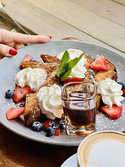 Product: TORRIJA FRENCH TOAST | brioche bread, milk batter, strawberry compote, strawberries, blueberries, maple syrup & whipped cream - Socarrat Paella Bar - Chelsea in Chelsea - New York, NY Spanish Restaurants