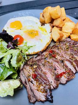 Product: STEAK & EGGS | skirt steak, two eggs any style, patatas bravas, market greens - Socarrat Paella Bar - Chelsea in Chelsea - New York, NY Spanish Restaurants