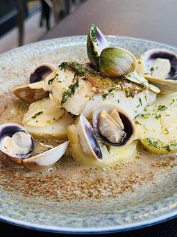 Product: BACALAO CON BERBERECHOS | cod loin, lemon potato confit, white wine, cockles, garlic, pars - Socarrat Paella Bar - Chelsea in Chelsea - New York, NY Spanish Restaurants