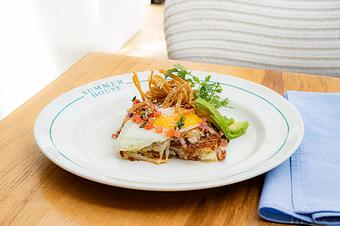 Product: Hash brown patty served with sunny side eggs, tomato salsa, oaxaca cheese, avocado, cilantro - Summer House - Las Vegas in Las Vegas, NV Restaurants/Food & Dining