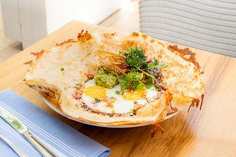 Product: Large oaxaca cheese quesadilla topped with ranchero sauce, sunny side eggs, crema, avocado, and tortilla strips - Summer House - Las Vegas in Las Vegas, NV Restaurants/Food & Dining