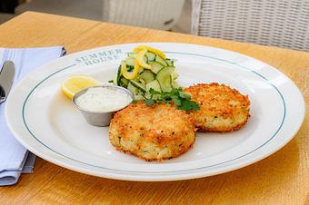 Product: Two jumbo lump blue crab cakes and a side of cucumber salad and remoulade - Summer House - Las Vegas in Las Vegas, NV Restaurants/Food & Dining