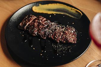 Product: grilled to medium rare over binchotan coals seasoned with house tare. sliced chopstick-friendly and drizzled with sweet soy and served with a smear of spicy chinese mustard - Sushi San - Reservations in River North - Chicago, IL Japanese Restaurants