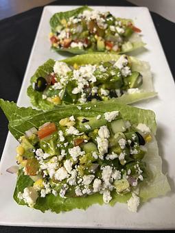 Product: Filled with feta cheese, red onion, corn, cherry tomato, avocado, black olive, red pepper, and cucumber. Tossed in a cilantro vinaigrette. - The Bowman in Parkville, MD American Restaurants