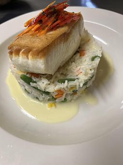 Product: Fresh fillet of halibut served atop a rice and vegetable medley, seated in a lemon-butter sauce. Finished with julienne carrots. - The Bowman in Parkville, MD American Restaurants