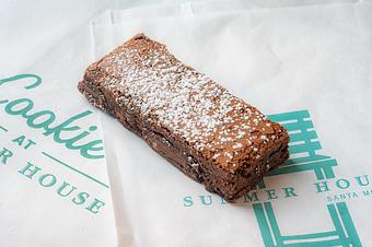 Product: Rectangular brownie made without gluten and topped with powdered sugar. - The Cookie Bar by Summer House in Chicago, IL Restaurants/Food & Dining