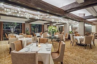 Interior: TRIBUTE Dining Room features a wall of windows offering stunning views of the beautiful wooded grounds of The Houstonian Hotel. - TRIBUTE at The Houstonian in Memorial - Houston, TX American Restaurants