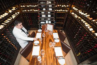 Product: Dine beside a waterfall of wine bottles in TRIBUTE's Wine Room, an intimate setting for up to 4 guests. This “secret” wine room is the city’s most intimate celebration hideaway. - TRIBUTE at The Houstonian in Memorial - Houston, TX American Restaurants