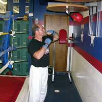 Rocky on the bag working out - Photos of Our Business -  Rocky's Dojo & Gym