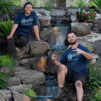 Our team of pond builders working on a backyard waterfall feature