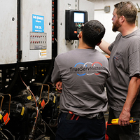 TrueServ Mechanical technicians working on a refrigeration system.