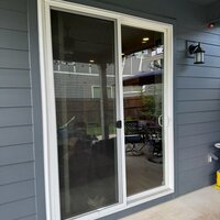 Before — shattered tempered glass on a residential patio sliding door in the Portland area.